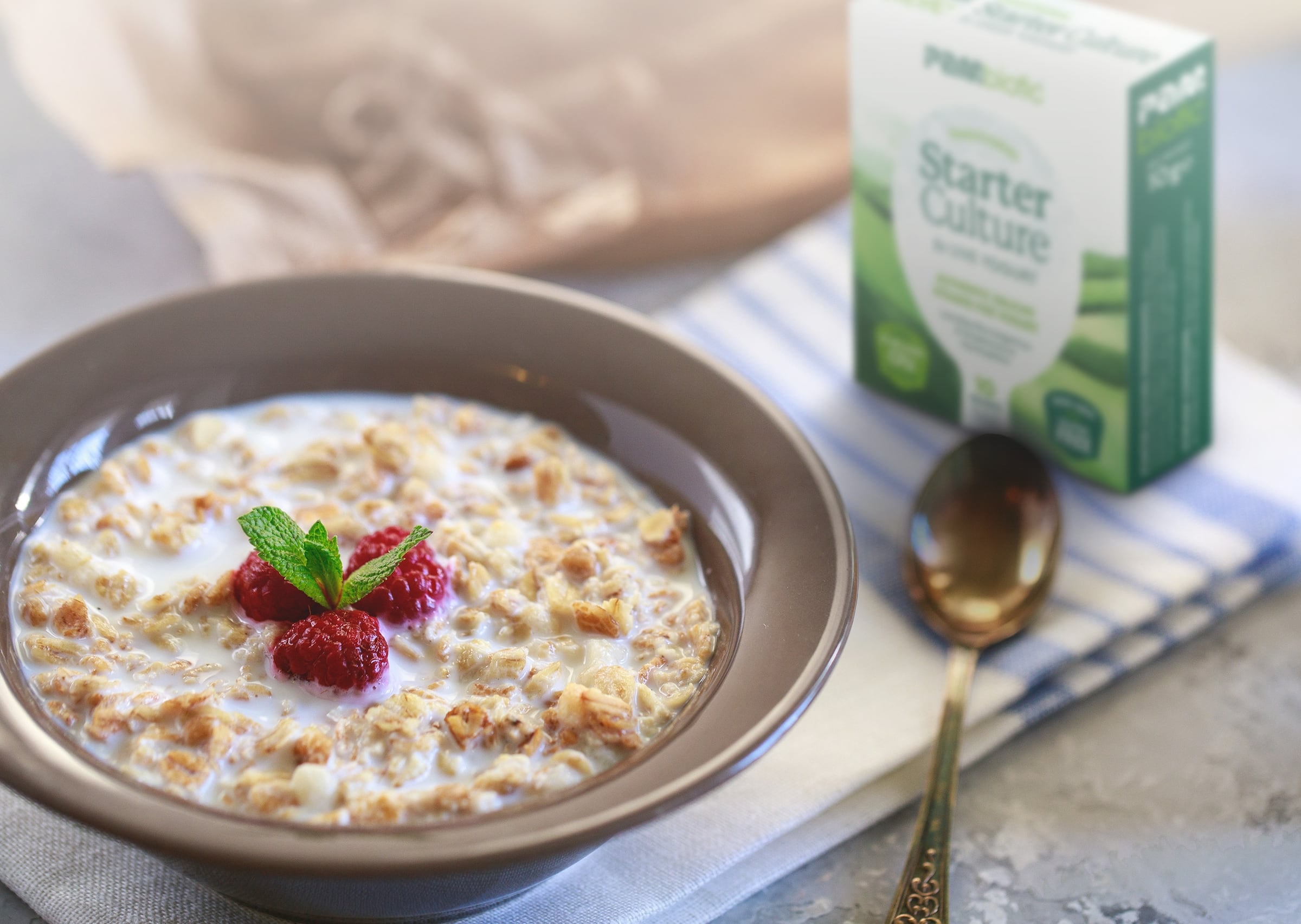 A breakfast bowl next to the Pambiotic yogurt starter box